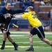 Blue Team player Mark Bihl stiff arms during the alumni spring flag football game on Saturday, April 13. AnnArbor.com I Daniel Brenner